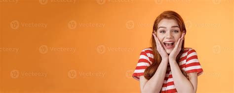 Close-up cute redhead cheerful girl look amazed yelling from joy lucky