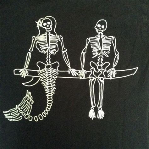 Two Skeletons Sitting On Top Of A Surfboard In Front Of A Black Shirt