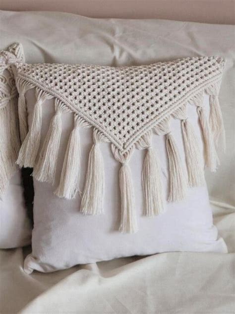 Two White Pillows With Tassels On Them