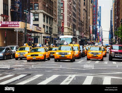 Yellow Taxis At The Street In New York Yellow Cars Serve As Taxis In