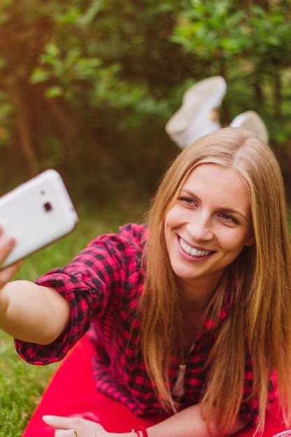 Premium Photo Smiling Young Woman Taking Selfie From Mobile Phone