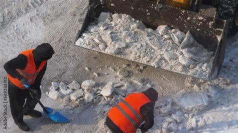 Video Stock Workers In Uniform With Shovels Shoveling Snow Into A