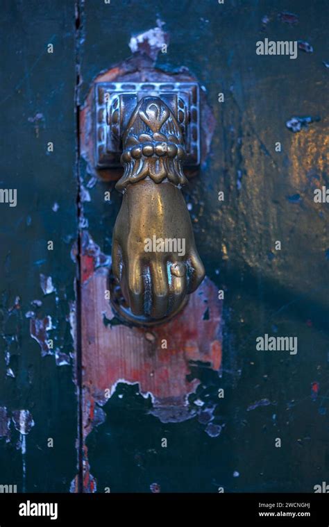 Bronze Hand As A Door Knocker On A Front Door In The Historic Centre