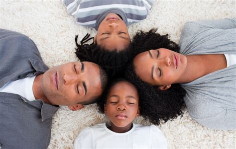 Familia Afroamericana Durmiendo En El Piso Con Las Cabezas Juntas