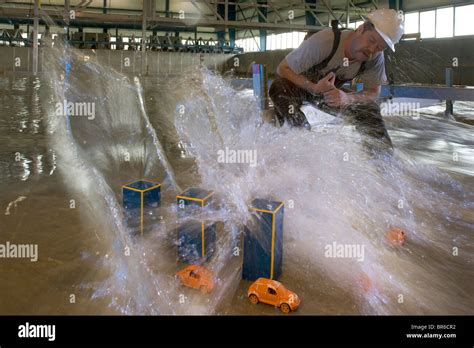 A Tsunami simulation wave topples model buildings Stock Photo - Alamy