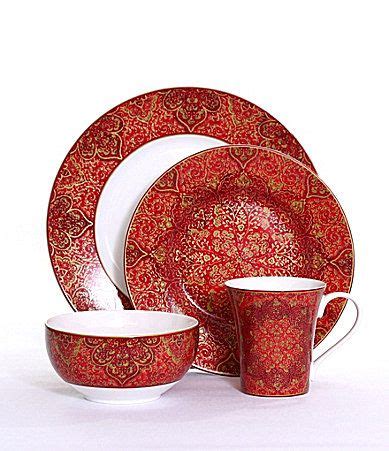 A Red And White Dinner Set With Matching Dishes