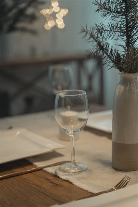 Clear Wine Glass On Brown Wooden Table · Free Stock Photo