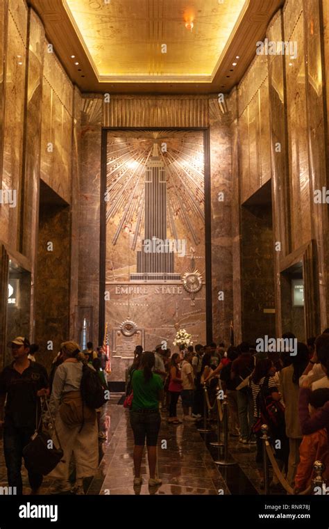 Cue of tourists in Empire State Building lobby and elevators Art Deco ...