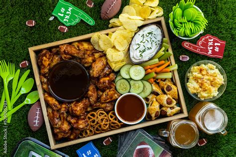 Overhead Shot Of Football Game Day Tailgate Party Food And Snacks With