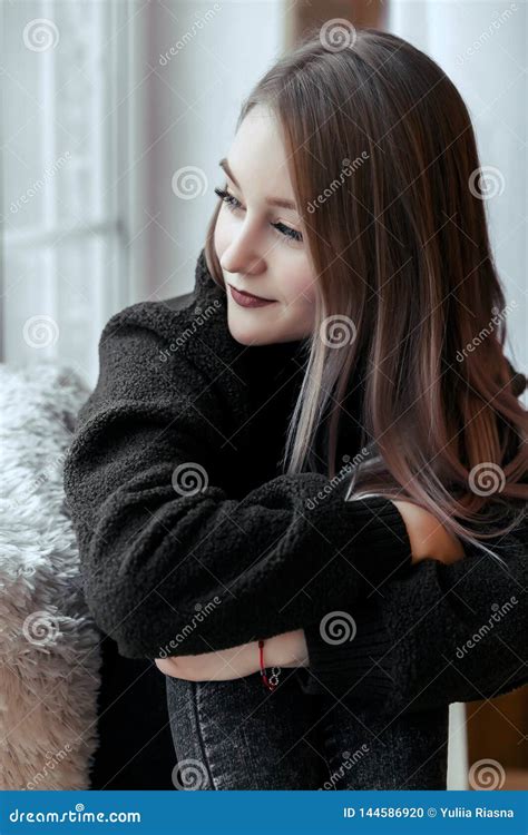 Beautiful Young Girl Sitting Alone on the Windowsill and Looking Out the Window Stock Photo ...