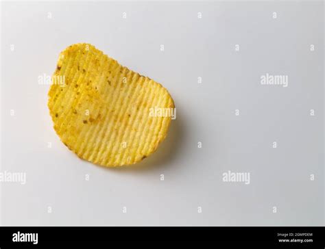 Single Salty Spicy Potato Crinkle Cut Chip Isolated On White Background