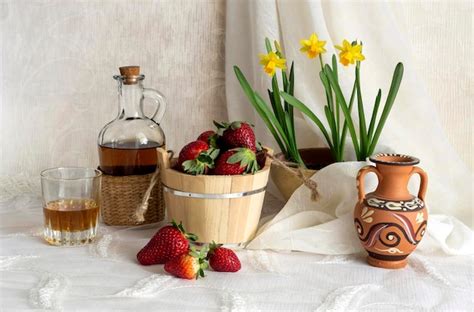 Premium Photo Still Life With Strawberries Brandy And Daffodils On A