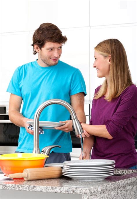 Young Man Helping His Wife In Household Stock Photo Image 36747492