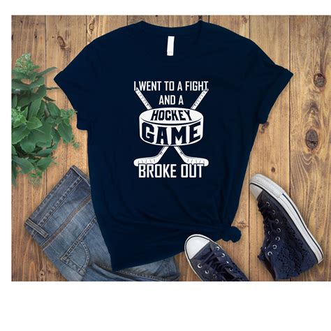 We love this funny hockey t-shirt. It features a hockey puck and two ...