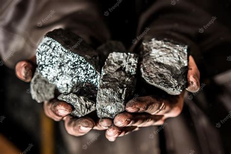 Premium Photo | Coal mining coal miner in the man hands of coal ...