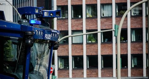 premium photo blue police water cannon truck  building