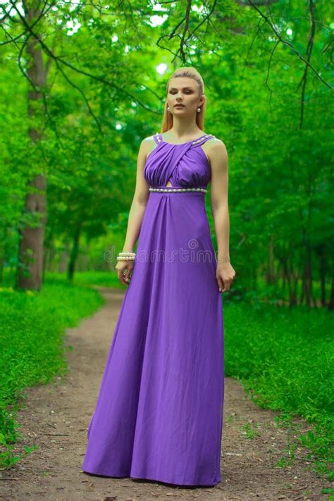 Blonde Beautiful Natural Girl With Blonde Hair In A Lilac Dress In Nature In The Park In The