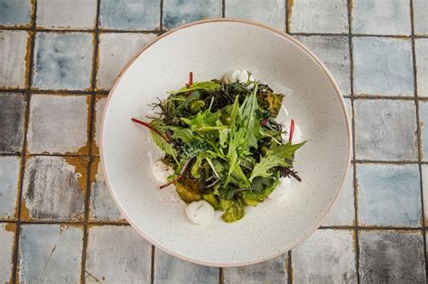 Premium Photo | Curly kale vegetable and white plate reshly harvested ...