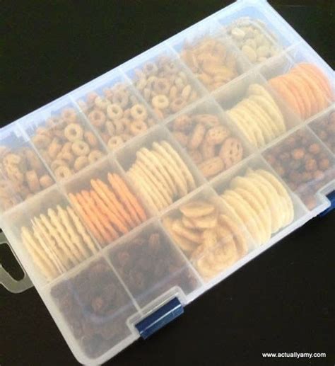 A Plastic Container Filled With Lots Of Different Types Of Snacks In It