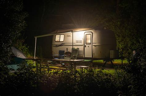 Caravan Trailer Glowing In Forest Camp Site Night Photograph By William