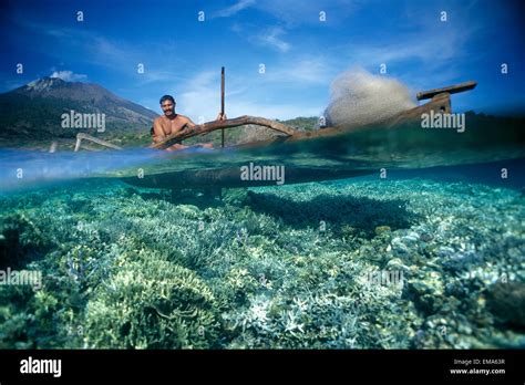 Indonesia Bali Fisherman In Wooden Boat Fishing Net Volcano