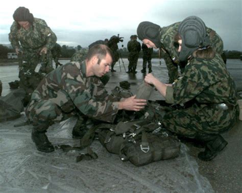 Staff Sgt Brion Helps Russian Sgt Helen Viliulina With Her Parachute