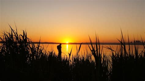 Premium Photo | Fisherman at sunset