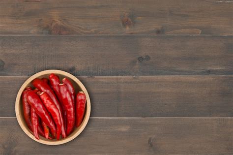 Premium Photo Red Chili Pepper In Bowl On Wooden Table