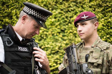 A Soldier From 2nd Battalion The Parachute Regiment With A Member Of