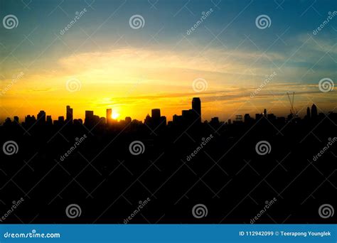 The Metropolis Is Full Of Tall Buildings At Sunset On The Horizon