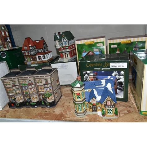 A COLLECTION OF BOXED CERAMIC CHRISTMAS VILLAGE BUILDINGS By