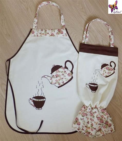 Two Aprons With Tea Cups On Them Sitting Next To Each Other