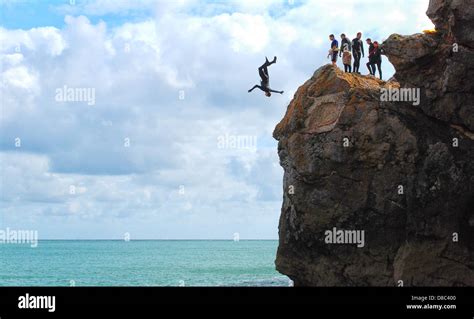 Man Jumping Off Cliff Sea High Resolution Stock Photography And Images