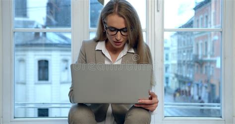 The Happy Beautiful Blonde Businesswoman With Glasses Is Laughing And