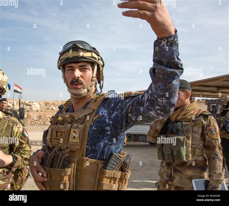 An Iraqi Federal Police Officer Manages Traffic Near Aski Mosul Iraq