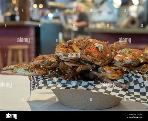 Steamed Chesapeake Bay Blue Crabs Covered In Seasoning Sitting In Paper Bowl On Paper Covered