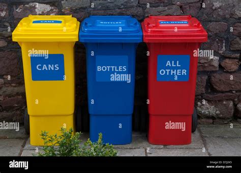 recycling bins, coloured, yellow, red,blue, three, against stone wall ...