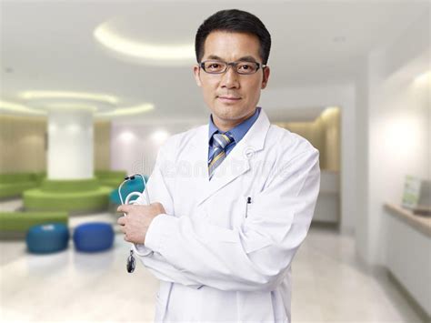 Asian doctor. Portrait of a male asian doctor in hospital lobby # ...