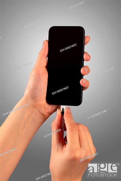 Close Up View Of Hand Charging Smartphone Stock Photo Picture And Low