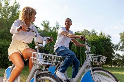 Premium Photo Africanamerican Couple Rides Bicycles In The Park And