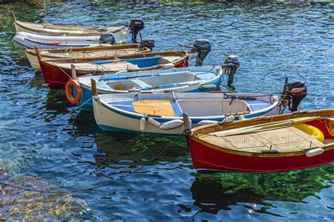 Colourful Fishing Boats Reflected In The Water In The Harbour Of