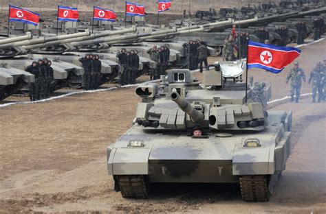 North Korean leader Kim Jong-un drives one of the new battle tanks ...