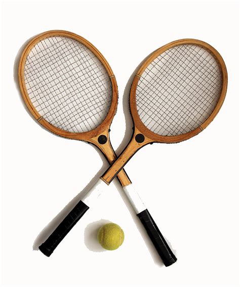 Two old wooden tennis rackets and tennis ball Photograph by Tom Conway