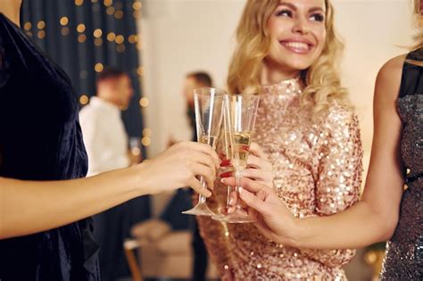 Premium Photo With Glasses Of Drink Group Of People Have A New Year Party Indoors Together