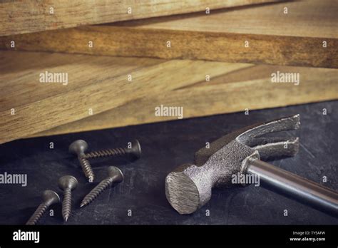 Close Up Hammer And Screw In Lumber Stacking Background Copy Space For