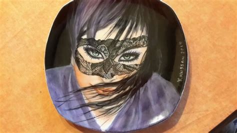 A Plate With A Woman S Face Painted On It And A Knife Next To It