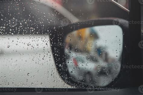 Drops Of Rain Drizzle On The Glass Windshield In The Evening Street In