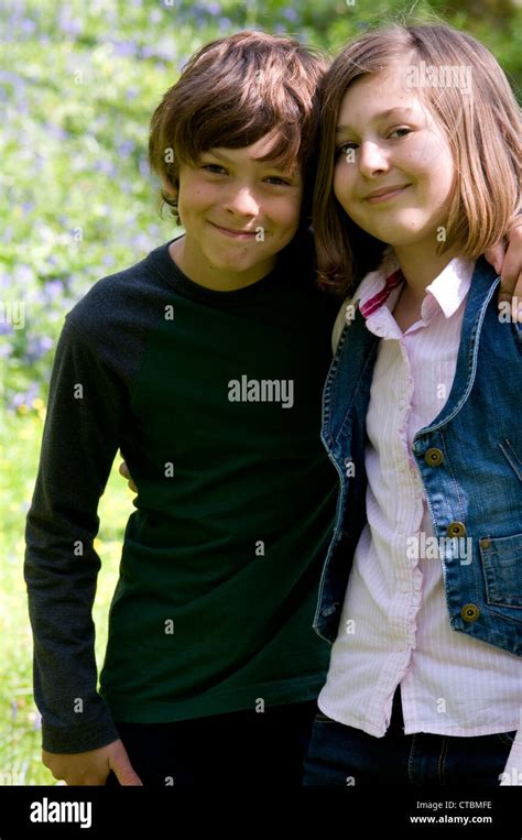 Portrait Of A Brother And Sister Smiling With Their Arms Around Each