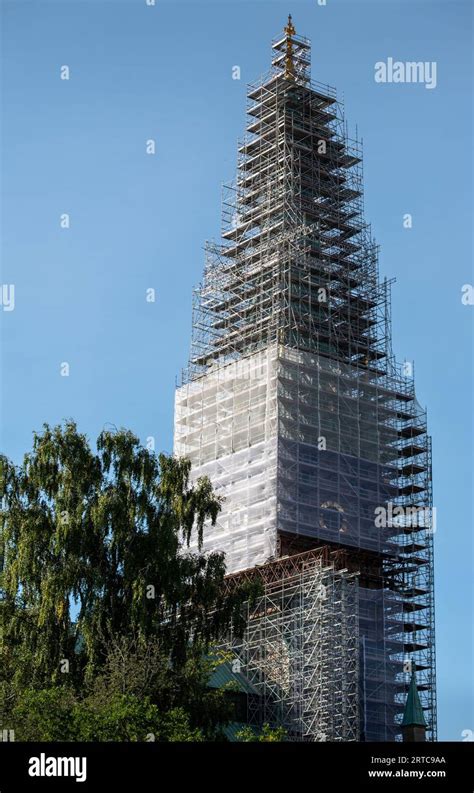 Linköping cathedral undergoing renovations, trees in the foreground ...