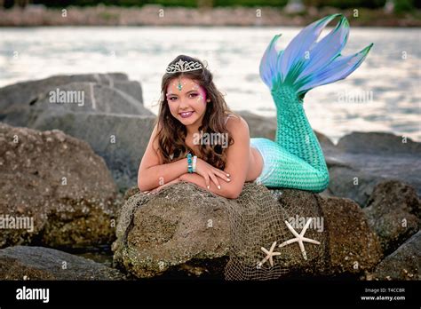 Tween Mermaid On Rocks Stock Photo Alamy